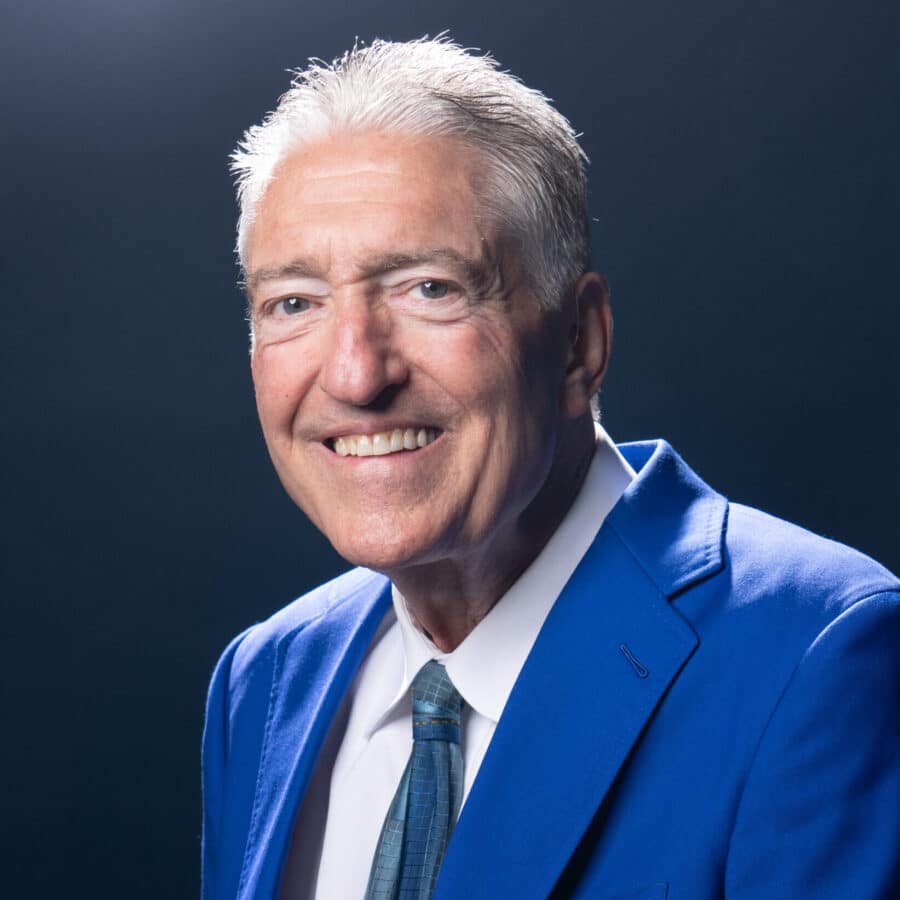 Pat Hughes, legendary Chicago Cubs radio broadcaster and 2023 Ford C. Frick Award winner, in his Cubs blue blazer