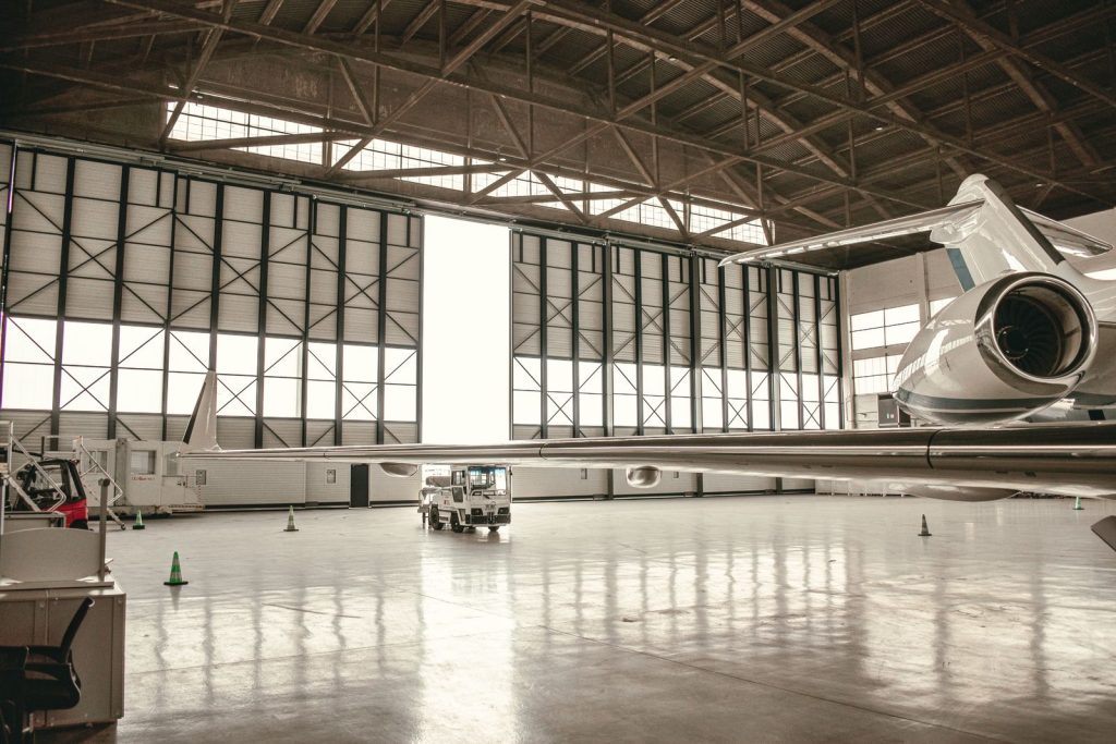 Business jet parked inside a maintenance hangar