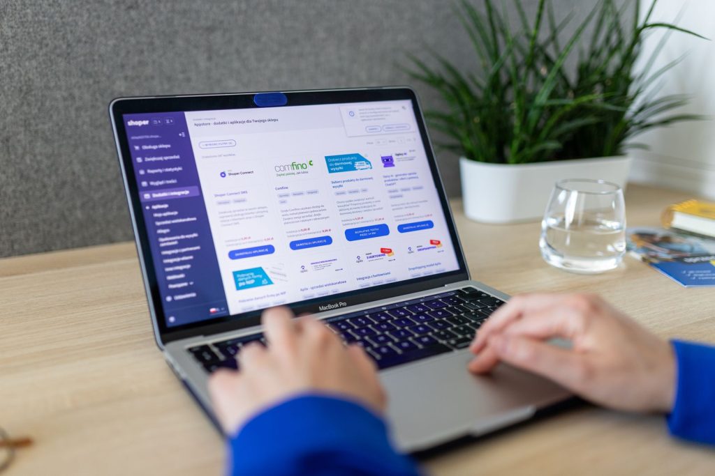 Sales professional researching prospects in a CRM on a laptop