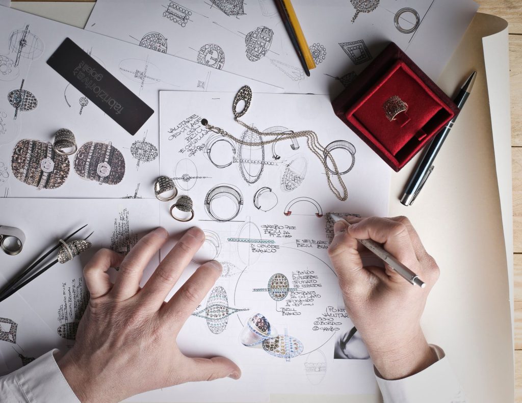 Designer sketching logo concepts on paper