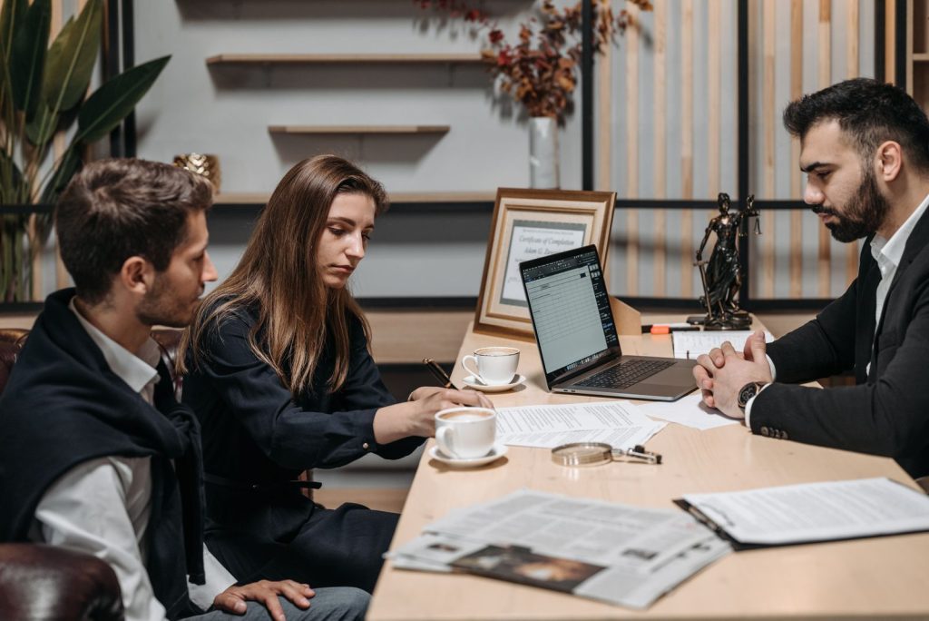Sales team meeting with prospective clients around a table