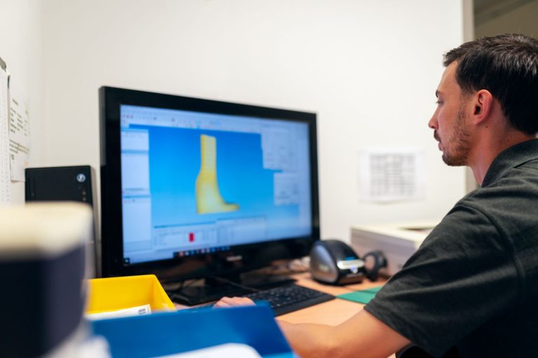 Engineer working at a computer with CAD software