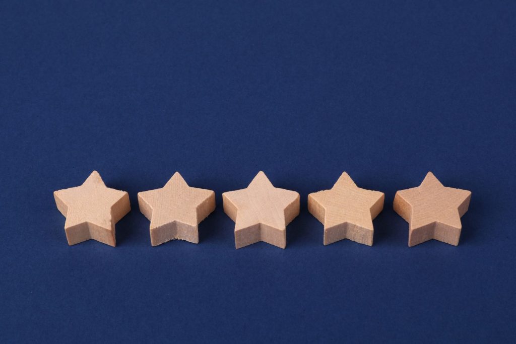 Five wooden stars representing a five-star review
