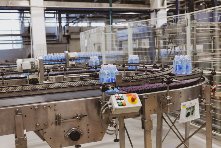 Food and beverage production line with bottles on a conveyor