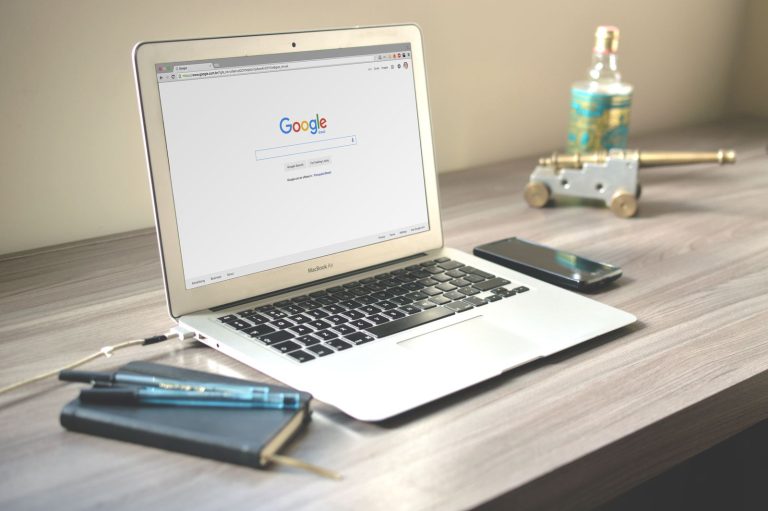 Laptop open to a Google search page on a desk