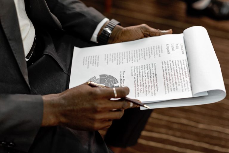 Professional reading a printed technical report