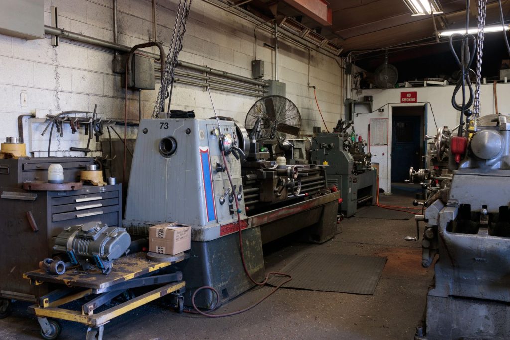 Machine shop floor lined with lathes and milling machines