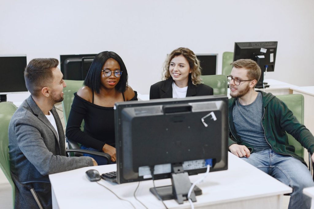 Sales and marketing team reviewing CRM data together at a computer