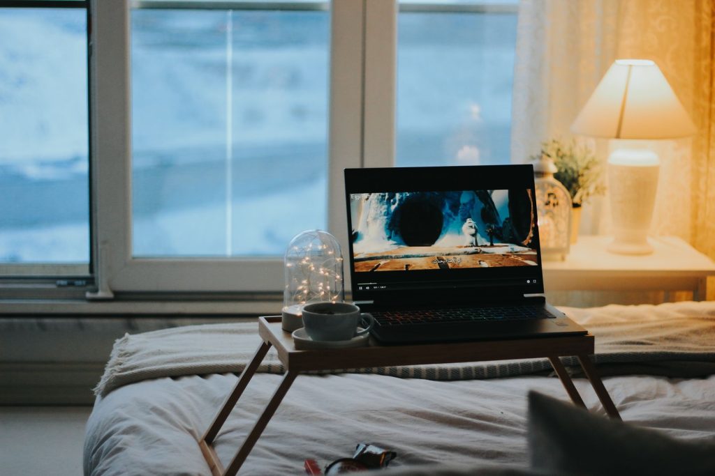 Laptop playing a video on a bedside table